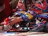 Mustang Lo Manthang Tiji Festival Day 3 06-2 Dorje Jono Stabs His Demon Father With A Phurba Dorje Jono takes a ritual dagger called a phurba and slowly moves it toward the torma cake representing his demon father. After a few false starts Dorje Jono inserts the phurba into the demon's heart on day three of the Tiji Festival in Lo Manthang. Is he satisfied that he has killed the demon?